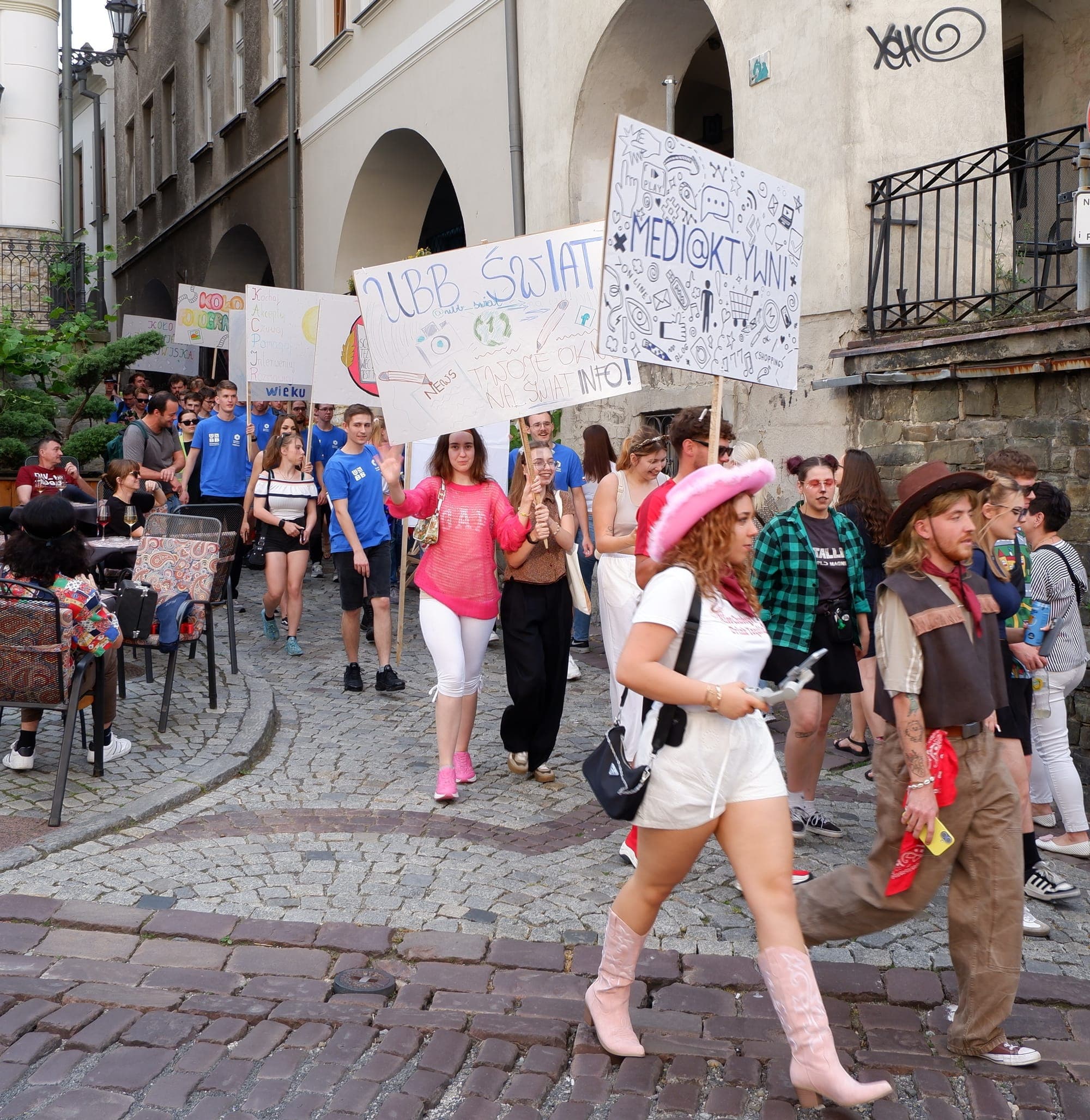 Students in costumes marching with handmade banners during the Juwenalia student festival