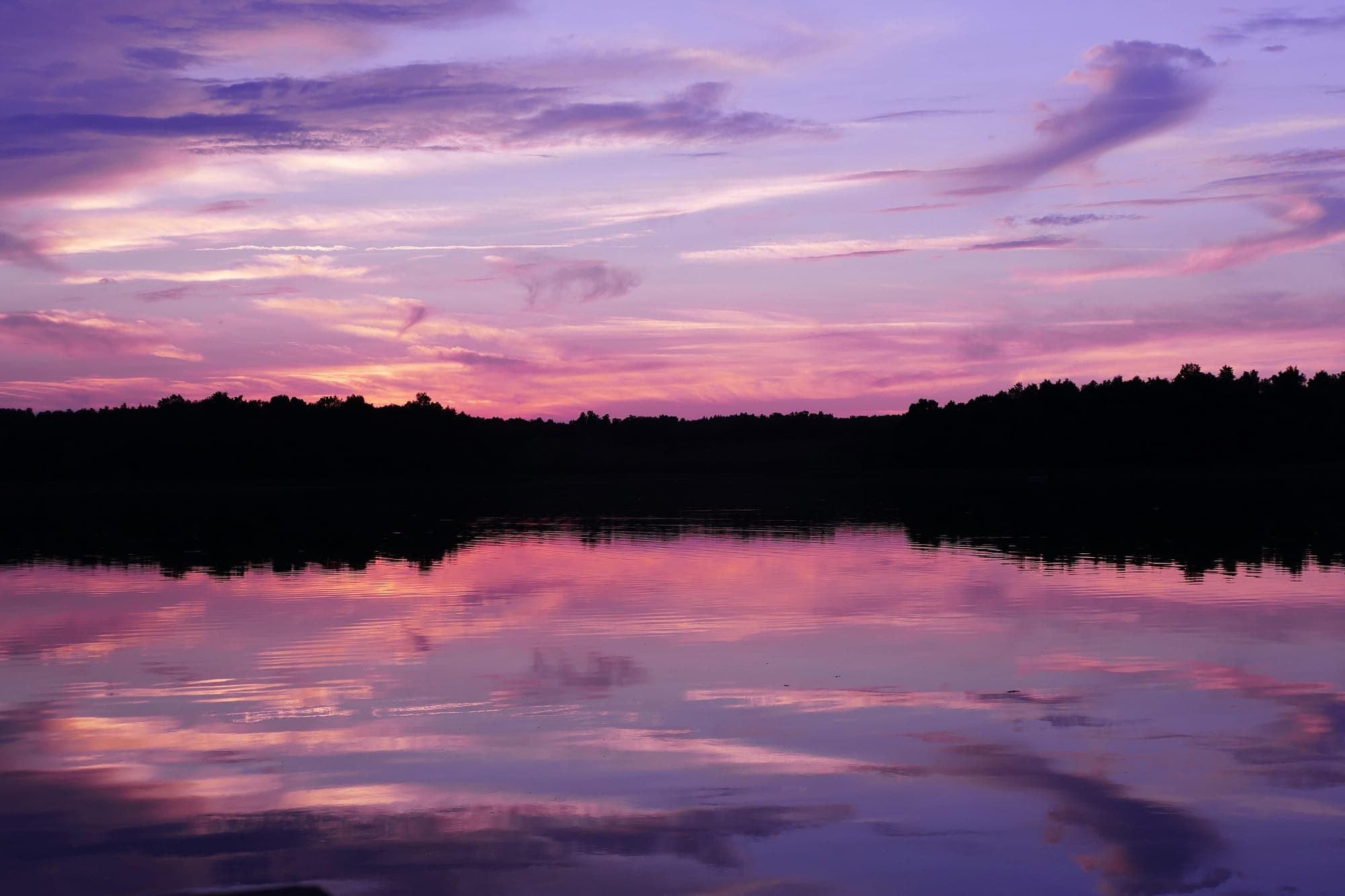 A Masurian lake at dusk under a violet sky